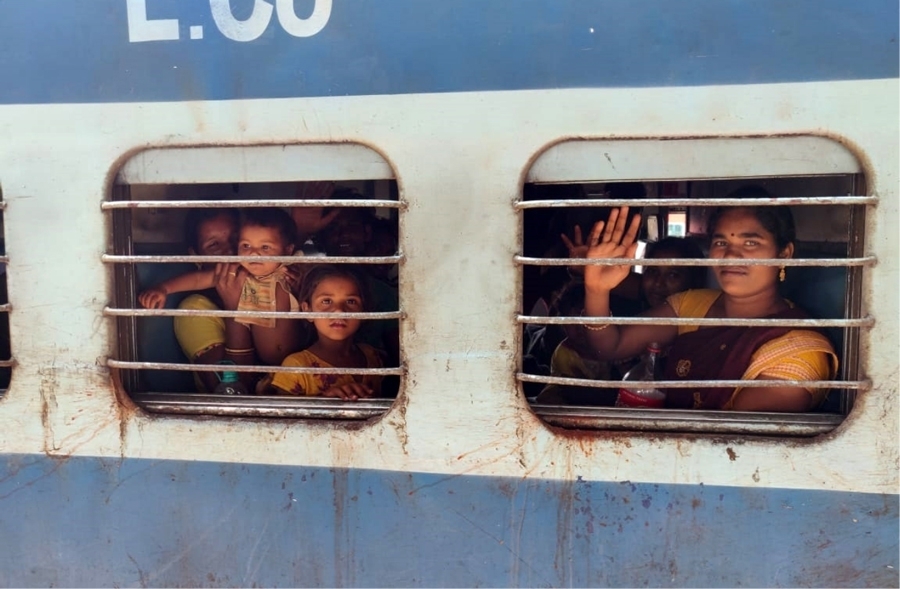 Indian women and chindren looking out of barred windows